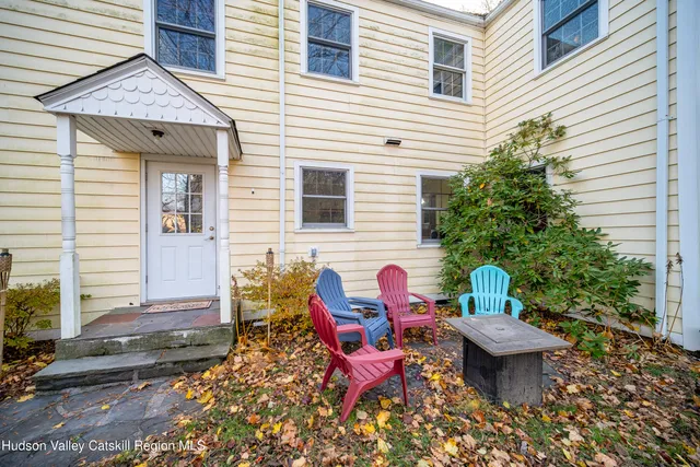 a view of a house with a backyard and sitting area