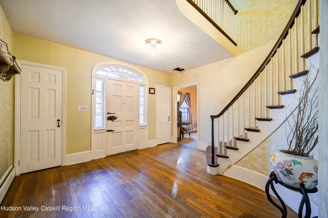 a view of an entryway with wooden floor and door