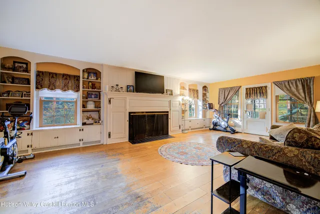 a living room with fireplace furniture and a flat screen tv
