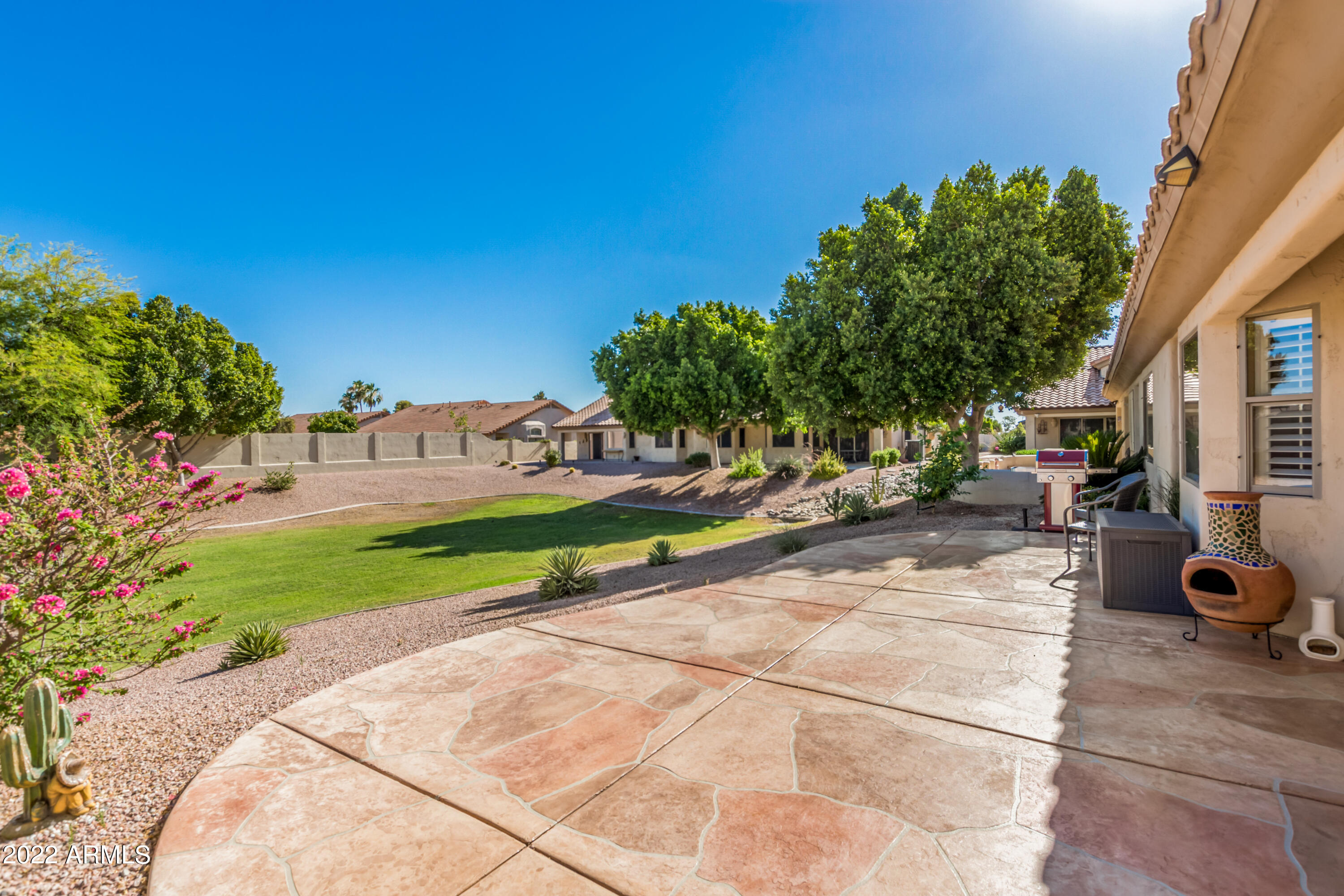 5830 East McKellips Road, Unit 76 Mesa, AZ 85215 - Photo 2 of 33 a view of a park with potted plants and large trees