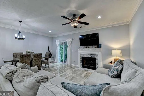 a living room with furniture a fireplace and a flat screen tv