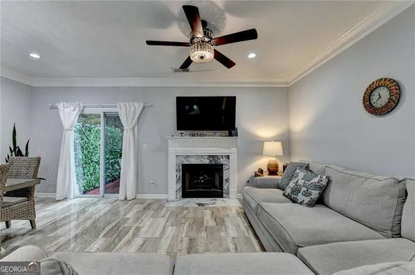 a living room with furniture a fireplace and a flat screen tv