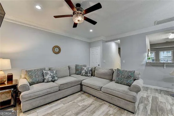 a living room with furniture and kitchen view