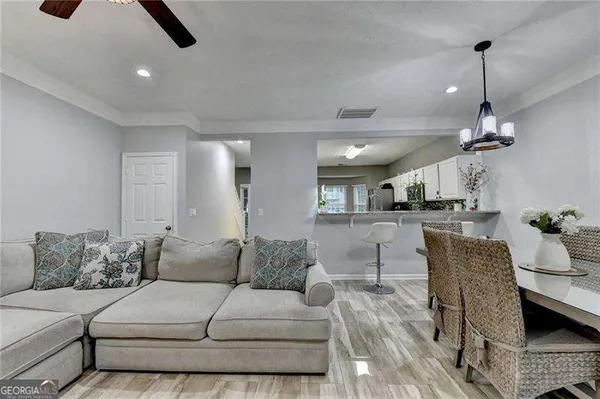 a living room with furniture and kitchen view