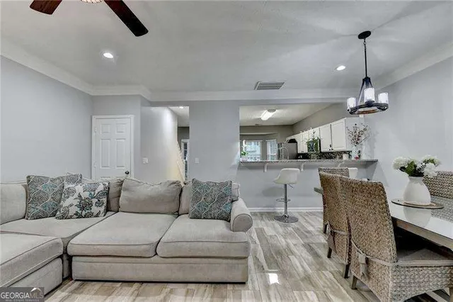 a living room with furniture and kitchen view