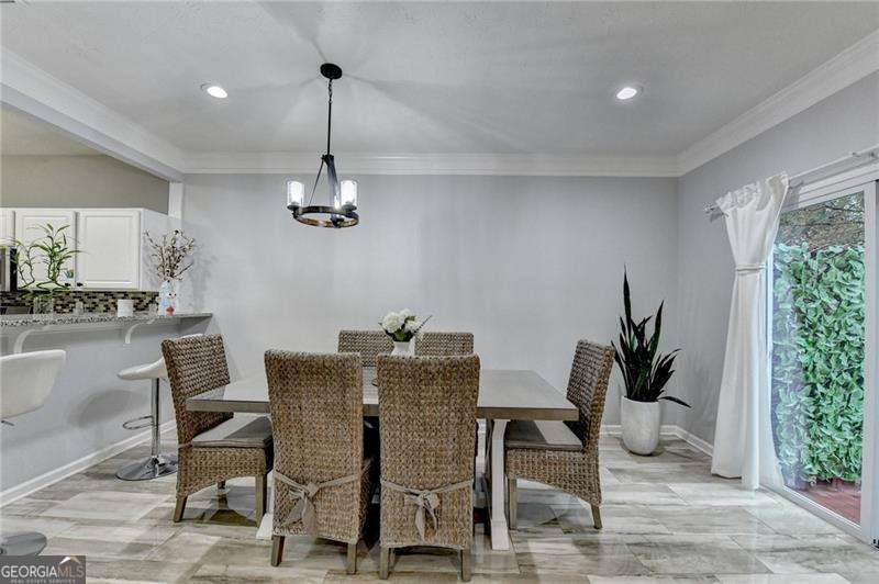 2066 Pinnacle Pointe Drive Norcross, GA 30071 - Photo 21 of 56 a dining room with furniture potted plants and wooden floor