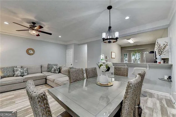 a living room with furniture a chandelier and a flat screen tv