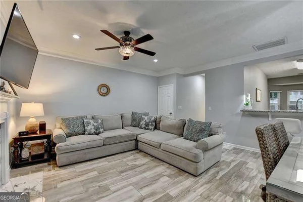a kitchen with a table chairs and a wooden floor
