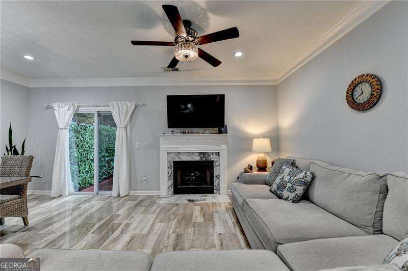 2066 Pinnacle Pointe Drive Norcross, GA 30071 - Photo 30 of 56 a living room with furniture a fireplace and a flat screen tv