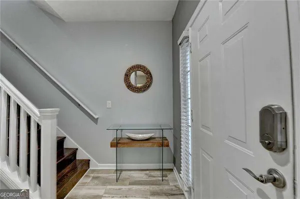 a view of entryway and gallery with wooden floor