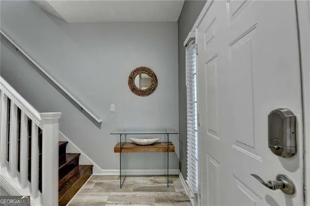a view of entryway and gallery with wooden floor