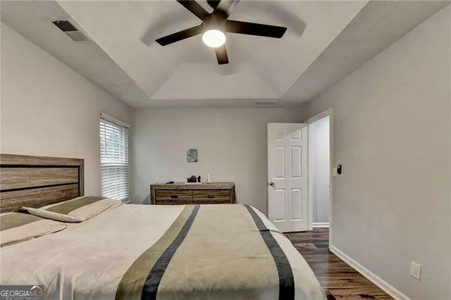 a bedroom with a large bed and a window