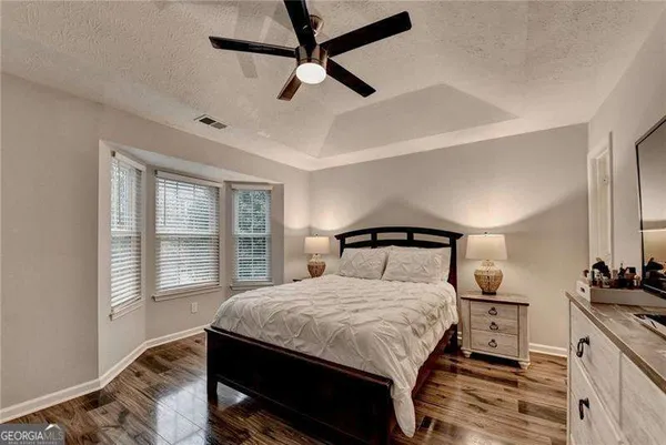 a bedroom with a bed and a flat screen tv