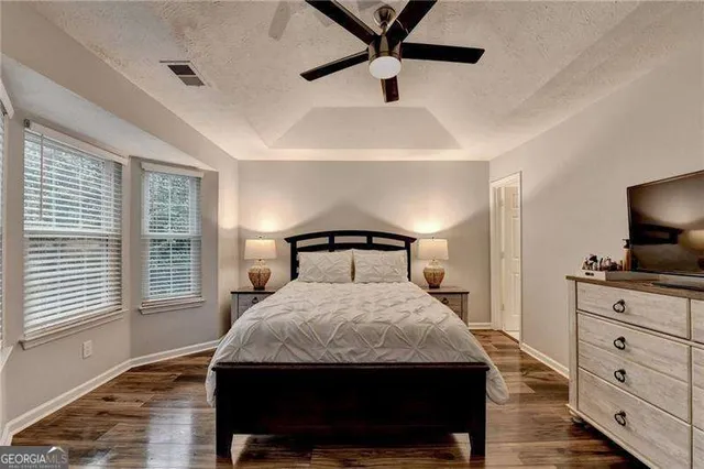 a bedroom with a large bed and a window