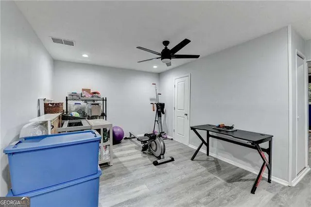 a bedroom with furniture and a ceiling fan