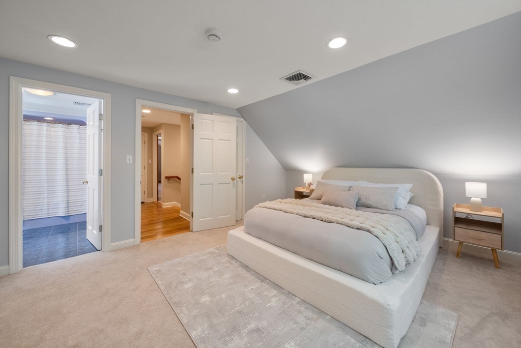 49 Walpole Street Dover, MA 02030 - Photo 26 of 40 a spacious bedroom with a bed and a table