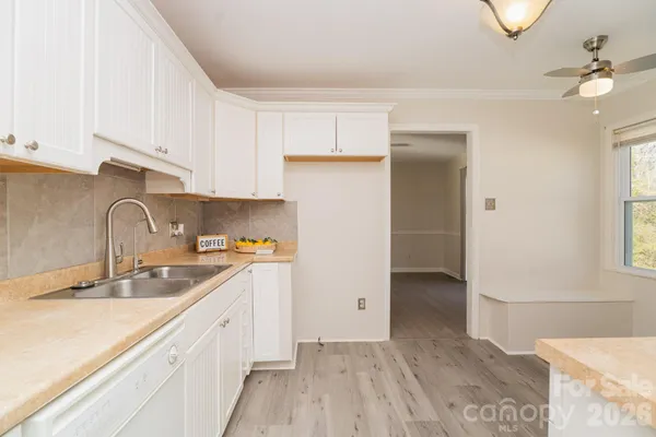 a kitchen with a sink cabinets and window