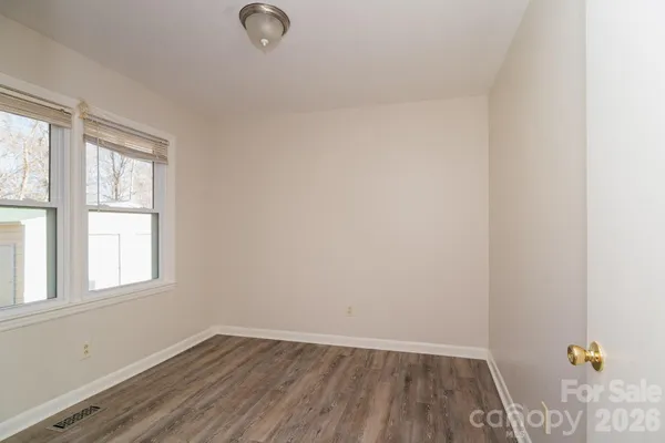 a view of an empty room and wooden floor