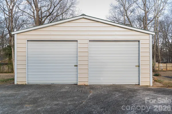 a view of a white house with a small space