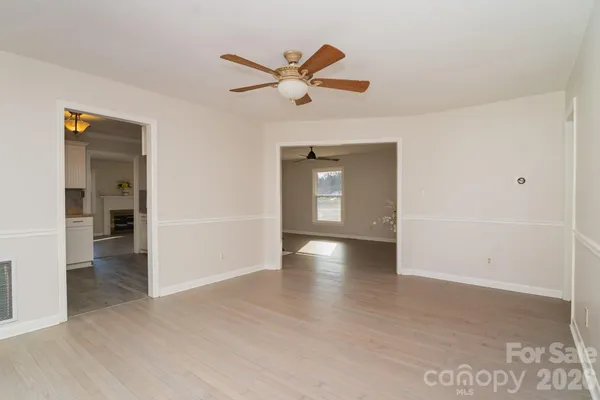 a view of a livingroom with a ceiling fan and wooden floor