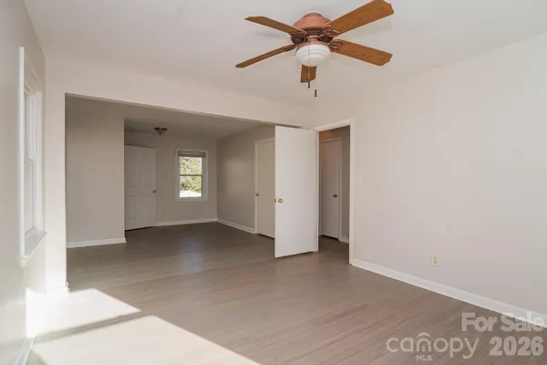 an empty room with a empty space and a ceiling fan