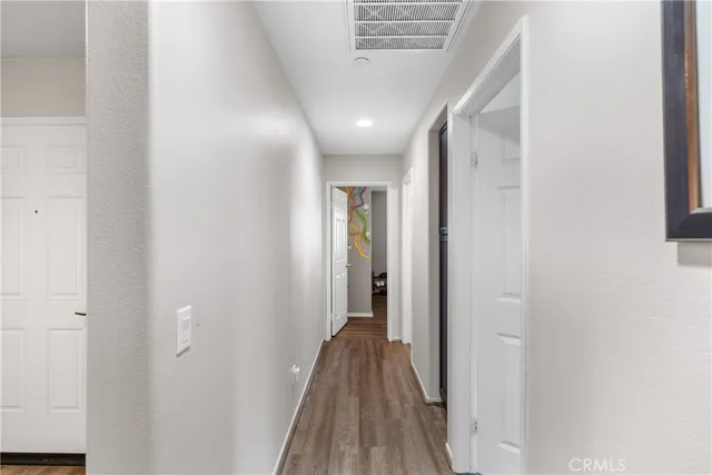 a view of hallway with wooden floor