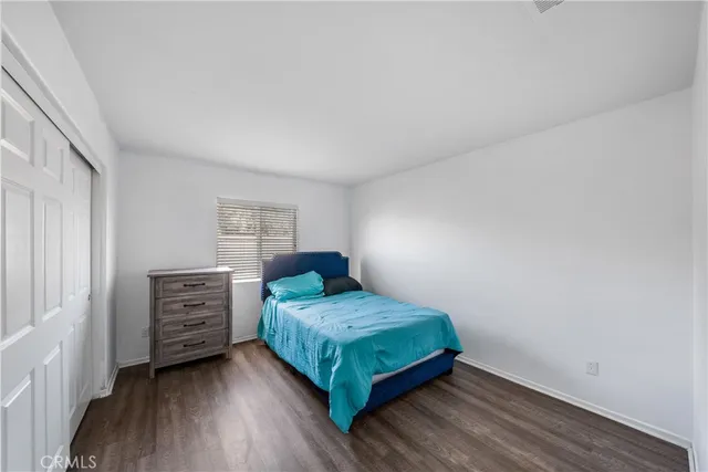 a bedroom with a bed and dresser