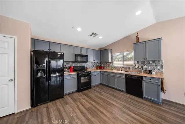 a kitchen with refrigerator and cabinets