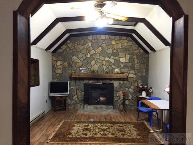 332 Claude Dickson Road Lansing, NC 28643 - Photo 3 of 18 a view of a livingroom with furniture and a fireplace