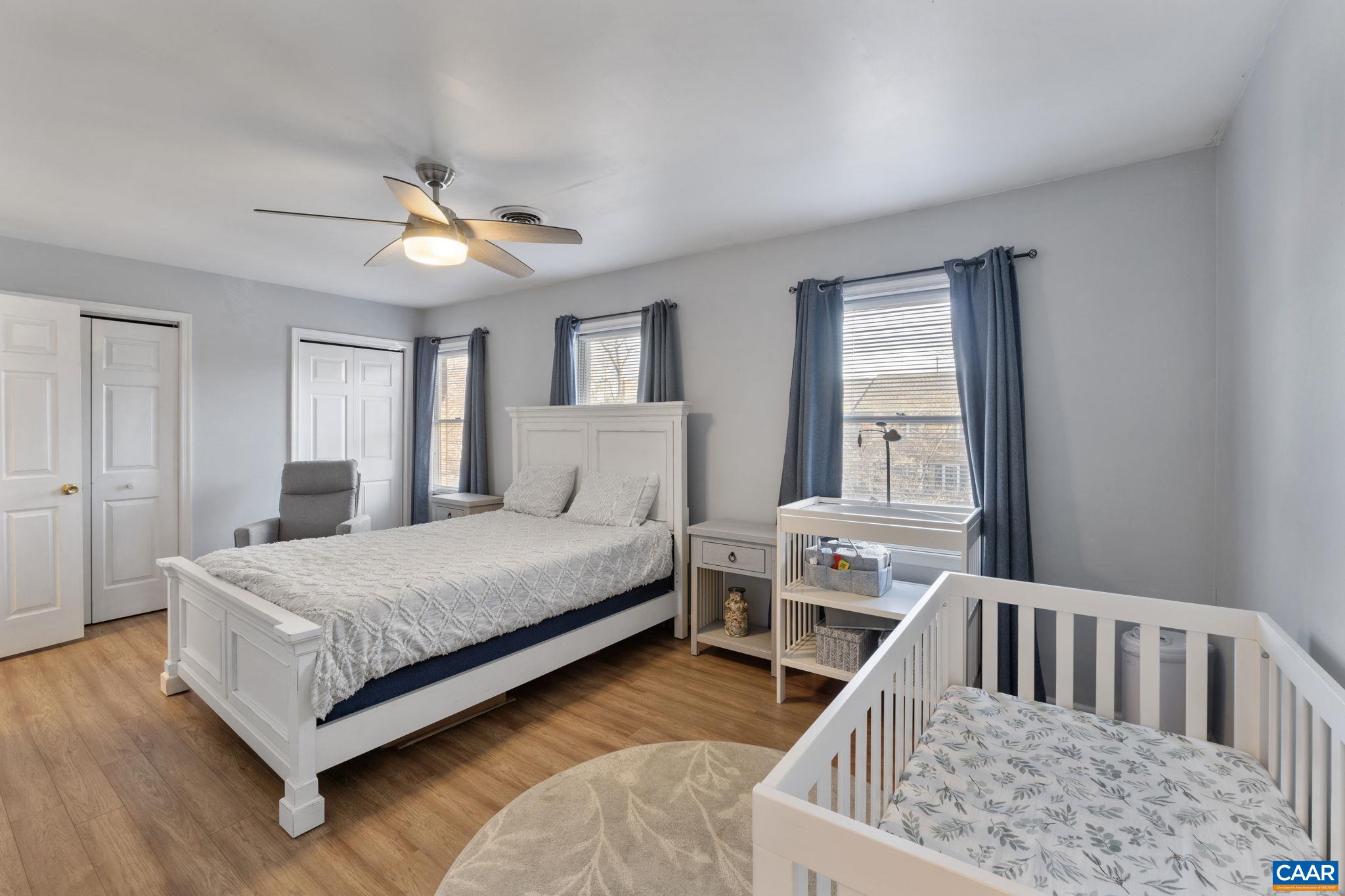 1540 Minor Ridge Court Charlottesville, VA 22901 - Photo 15 of 26 a bedroom with a bed a chandelier and dresser