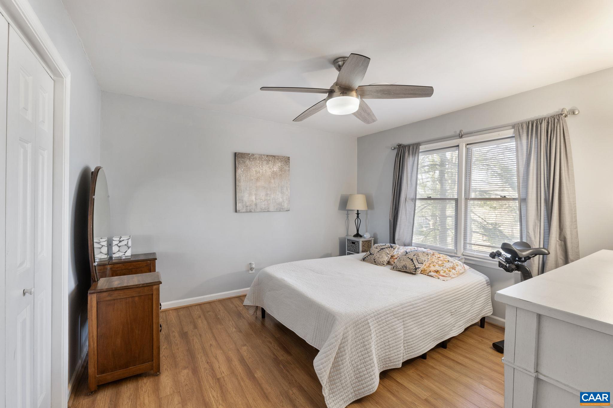 1540 Minor Ridge Court Charlottesville, VA 22901 - Photo 19 of 26 a bedroom with a bed and wooden floor