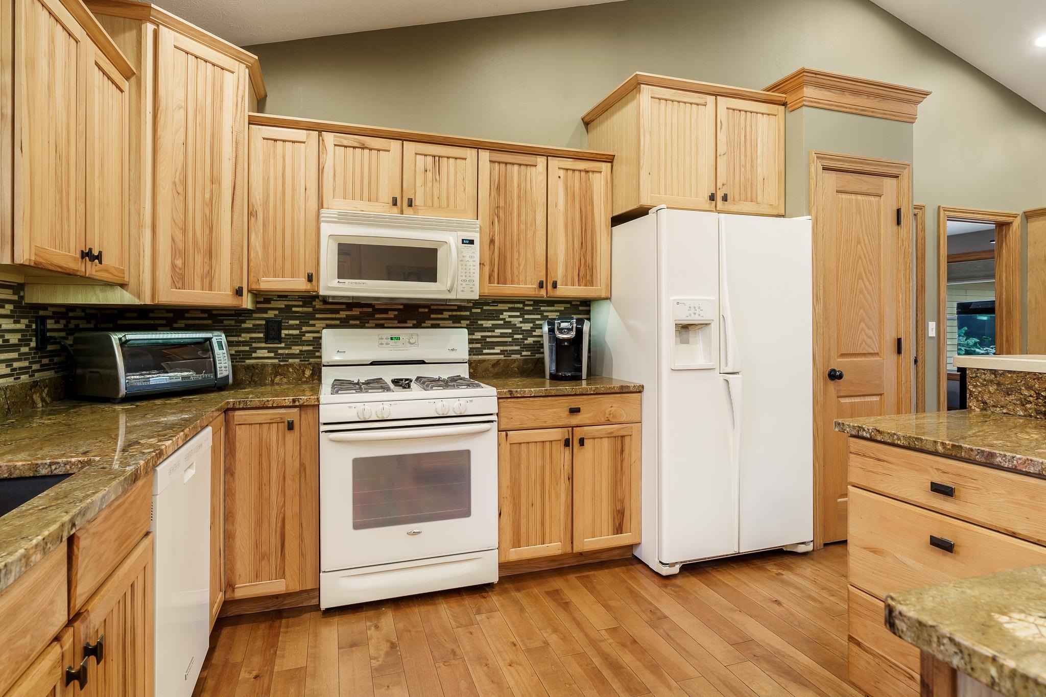2615 Graham Road Belvidere, IL 61008 - Photo 18 of 39 a kitchen with stainless steel appliances white cabinets and wooden floor