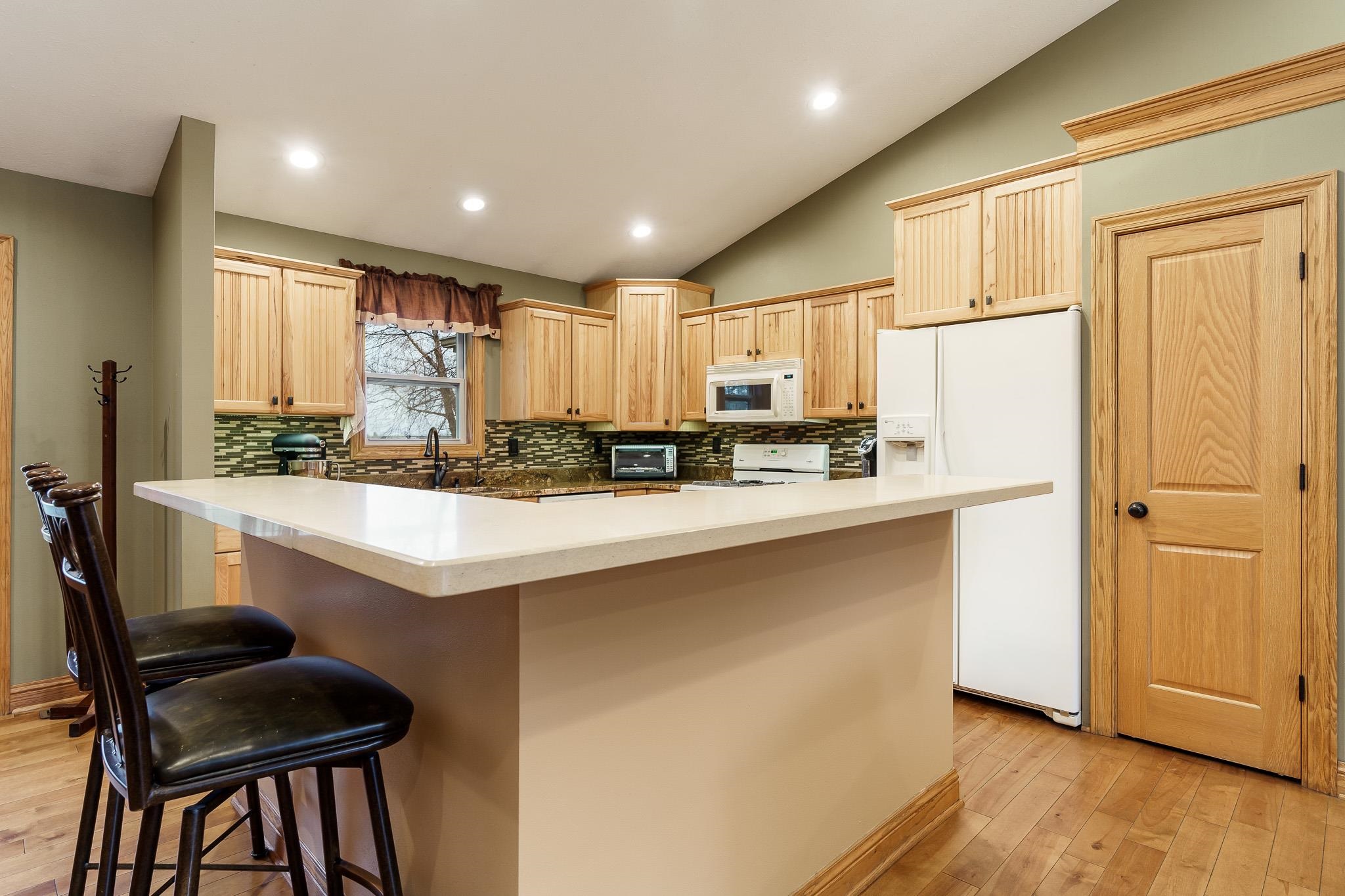 2615 Graham Road Belvidere, IL 61008 - Photo 22 of 39 a kitchen with kitchen island a stove a sink a refrigerator and cabinets