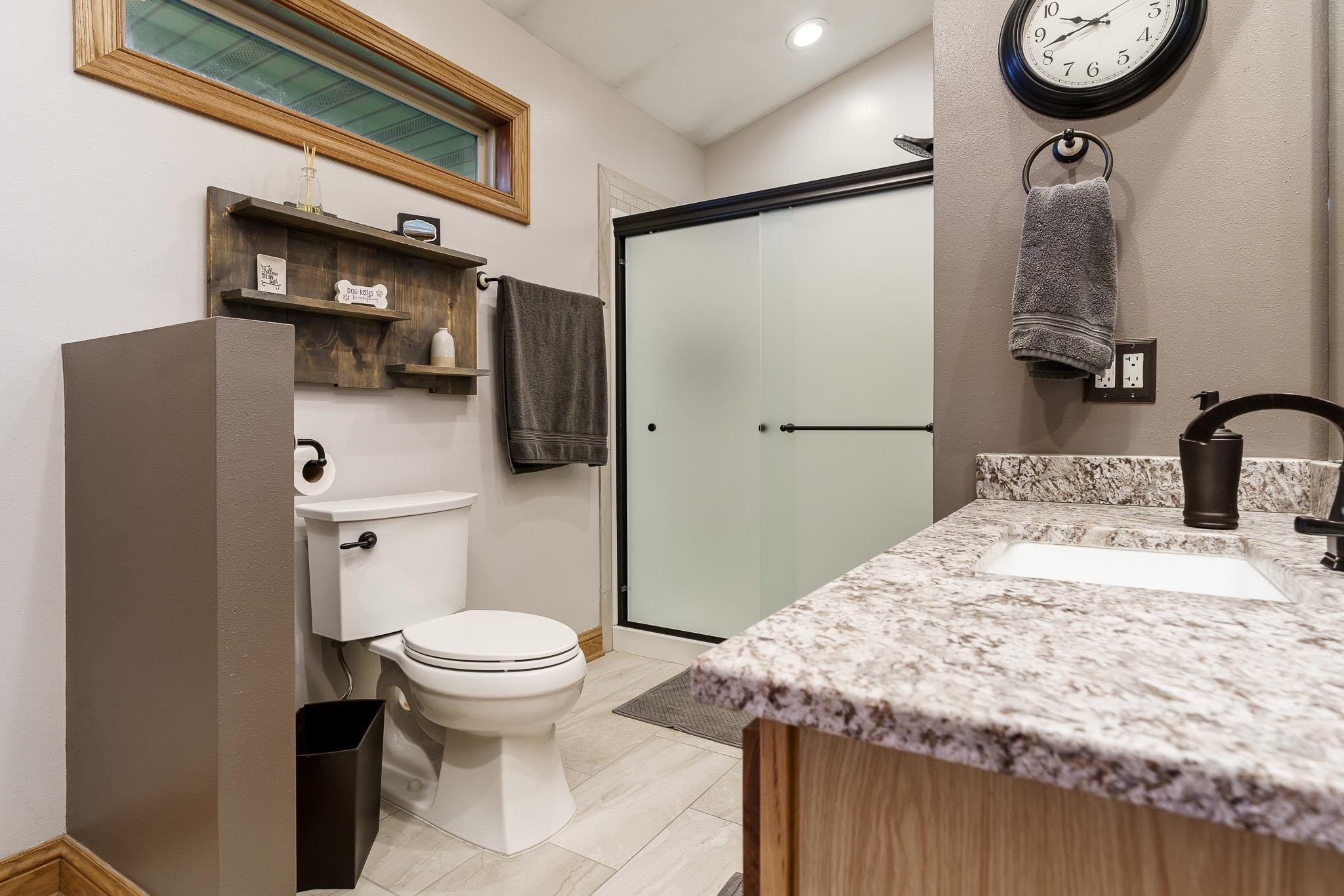2615 Graham Road Belvidere, IL 61008 - Photo 31 of 39 a bathroom with a granite countertop sink toilet and a mirror