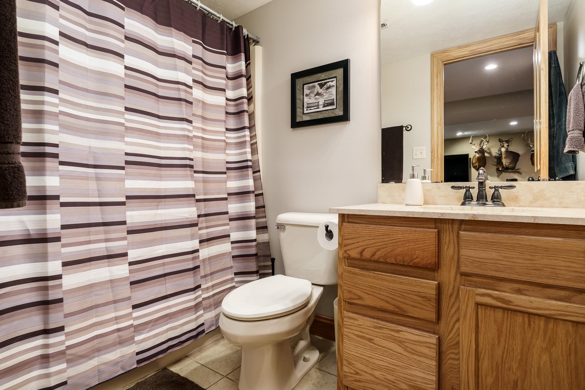 2615 Graham Road Belvidere, IL 61008 - Photo 37 of 39 a bathroom with a toilet a sink and mirror