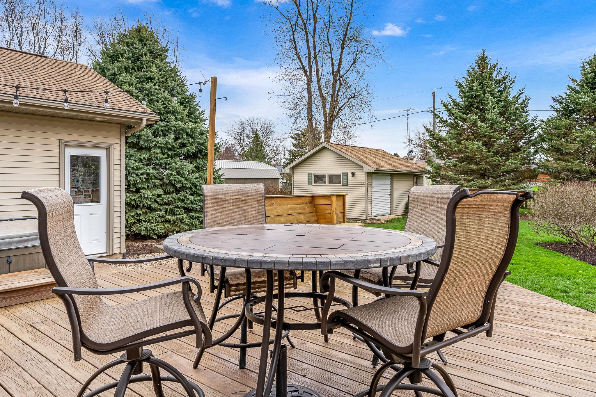 2615 Graham Road Belvidere, IL 61008 - Photo 10 of 39 a view of a patio with table and chairs with wooden floor and fence