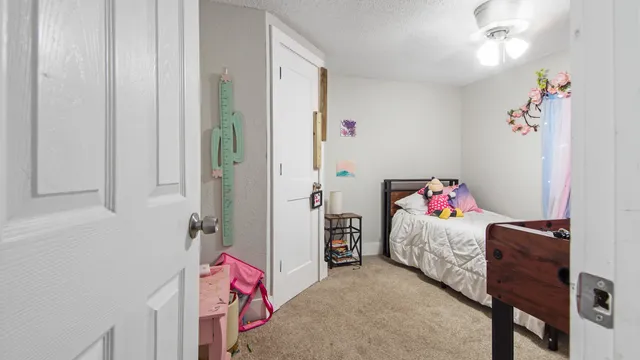 a bedroom with a bed and a chandelier
