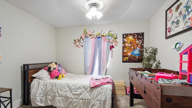 a bedroom with a bed and a window