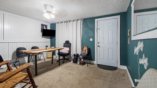 a view of a livingroom with furniture and a window