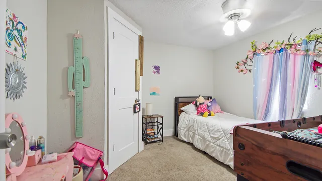 a bed room with a bed table and a couch