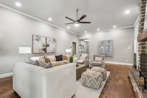 a living room with furniture and a wooden floor