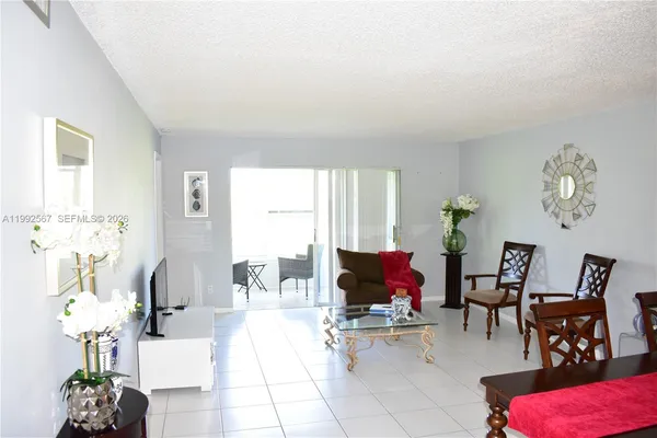 a living room with furniture flowerpot and flower pot