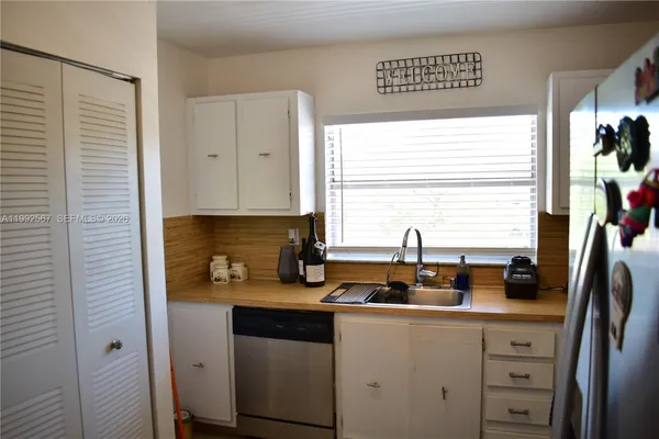 a kitchen with a sink cabinets and window