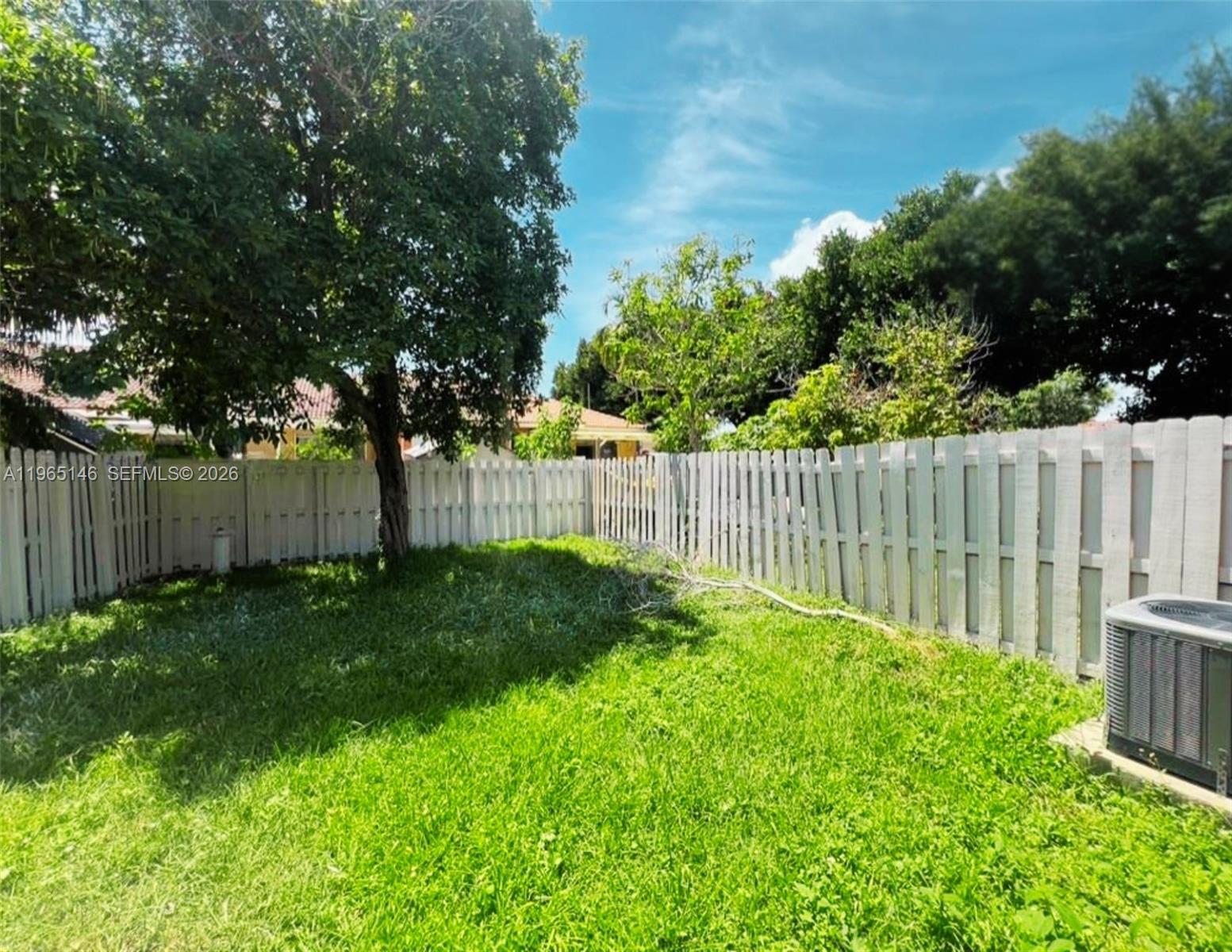 23712 Southwest 110th Avenue Homestead, FL 33032 - Photo 6 of 7 a view of a backyard with a trees