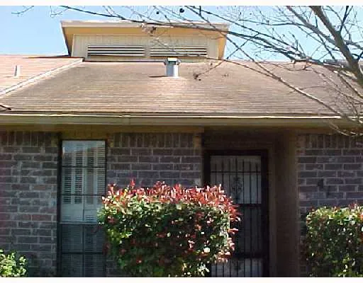 a front view of house with flowers