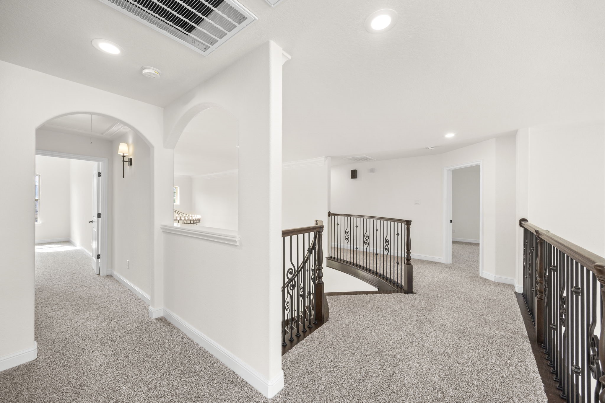 8551 Tombron Grove Road Magnolia, TX 77354 - Photo 34 of 49 The upper-level hallway overlooking the staircase offers bright and elegant transition between the home's secondary living spaces.