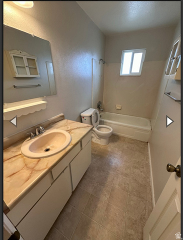 106 East Richelman Lane Wellington, UT 84542 - Photo 8 of 35 Full bathroom with vanity, shower combination, and a textured wall