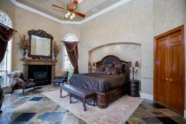 a bedroom with a bed and a potted plant