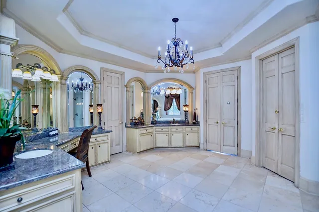 a bathroom with a tub sink and mirror