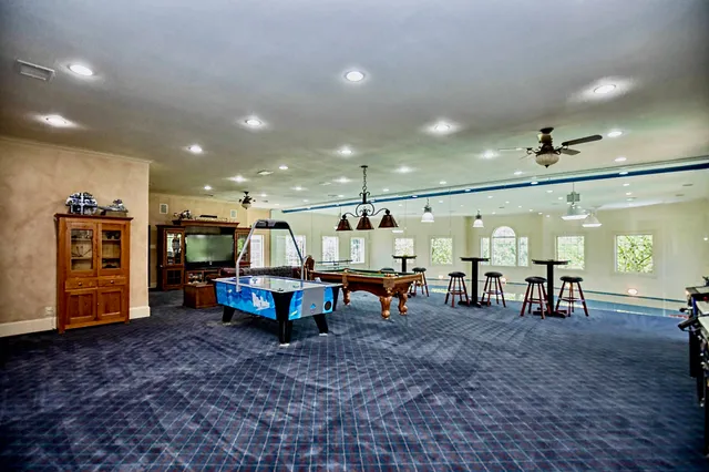 a room with lots of furniture and a wooden floor